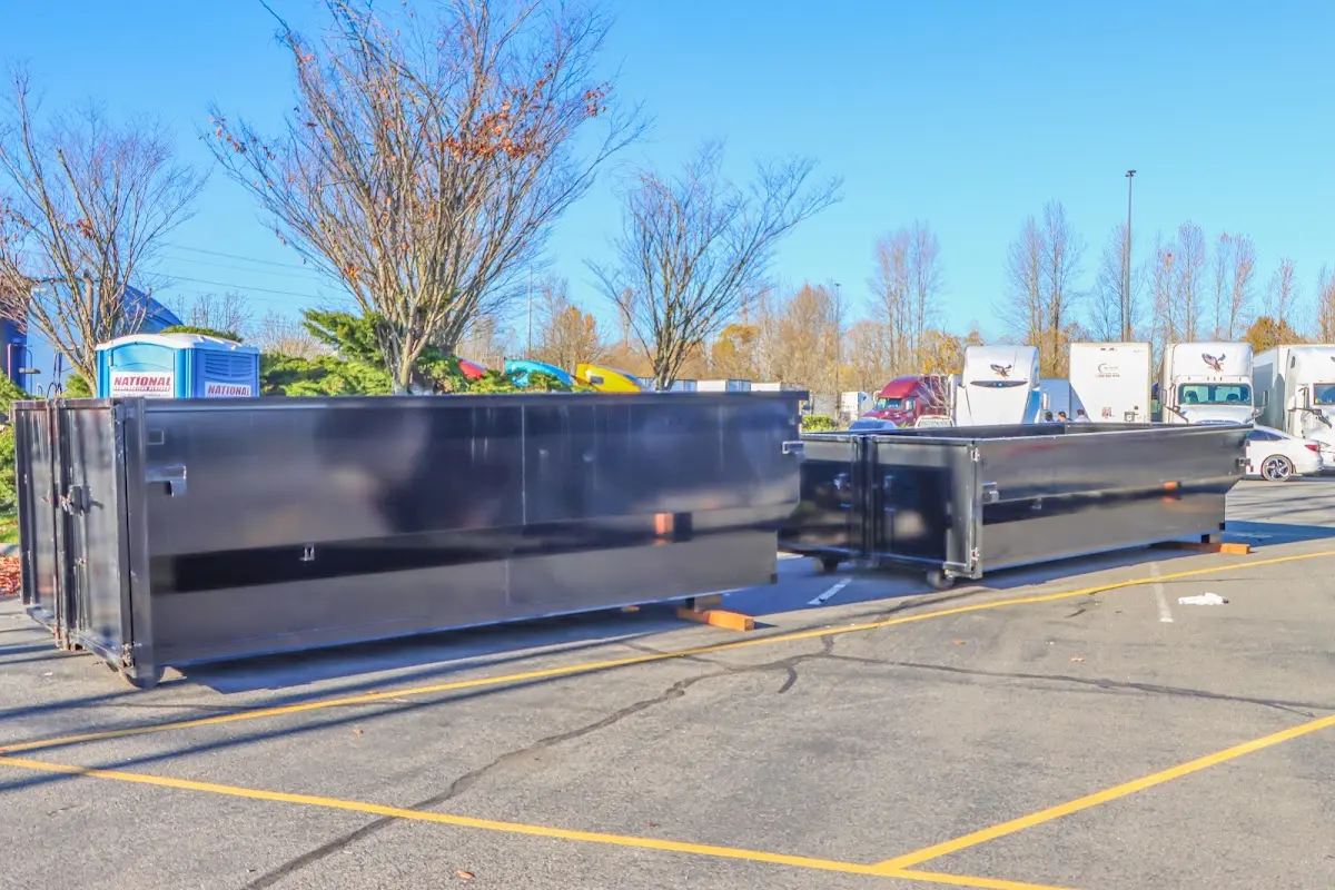 Professional dumpster rental service with roll-off container on residential driveway in Westview